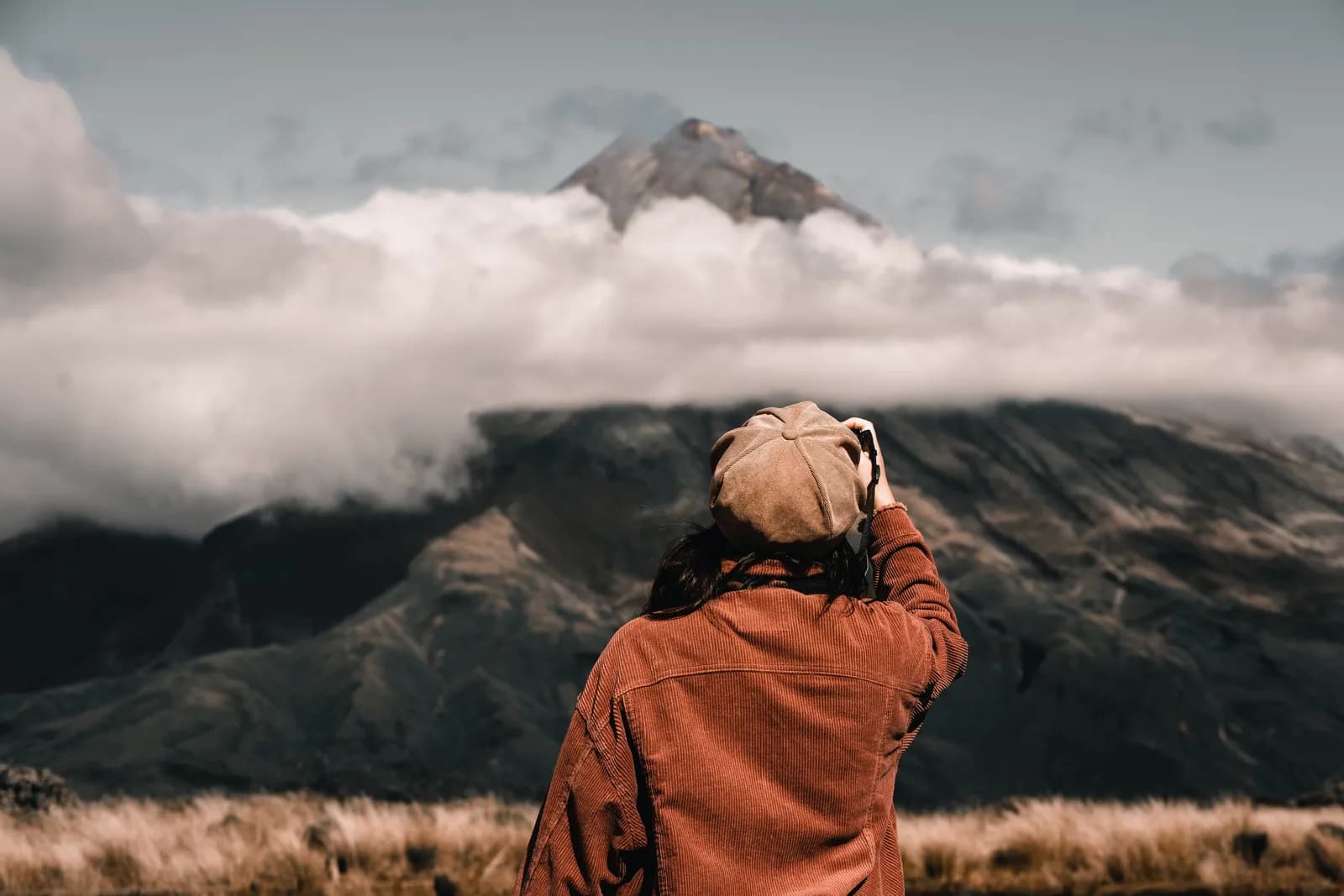 A trekker standing in silence, looking out at a Himalayan ridge